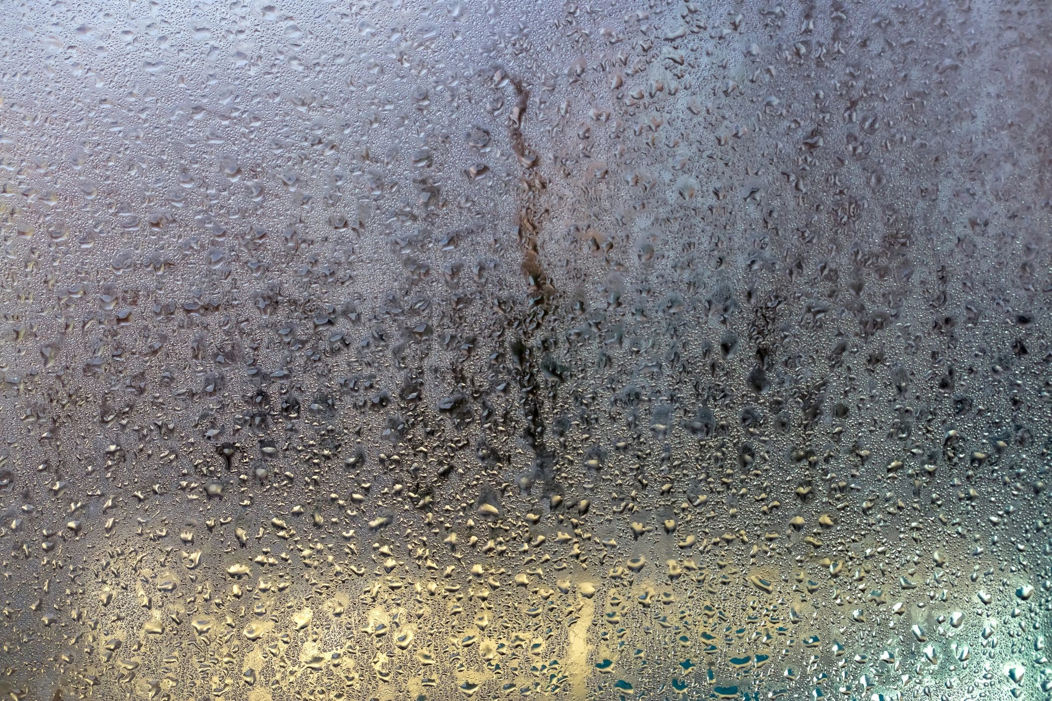 Rain-speckled window creating a calm reflective mood