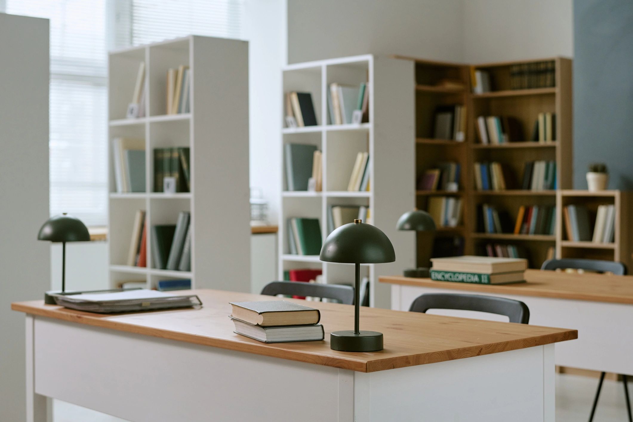 Quiet library-style reading space with desks and books